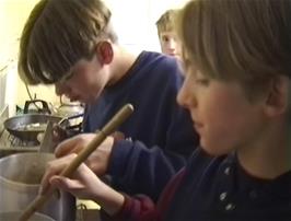 Food prep in the cramped kitchen at Perranporth youth hostel